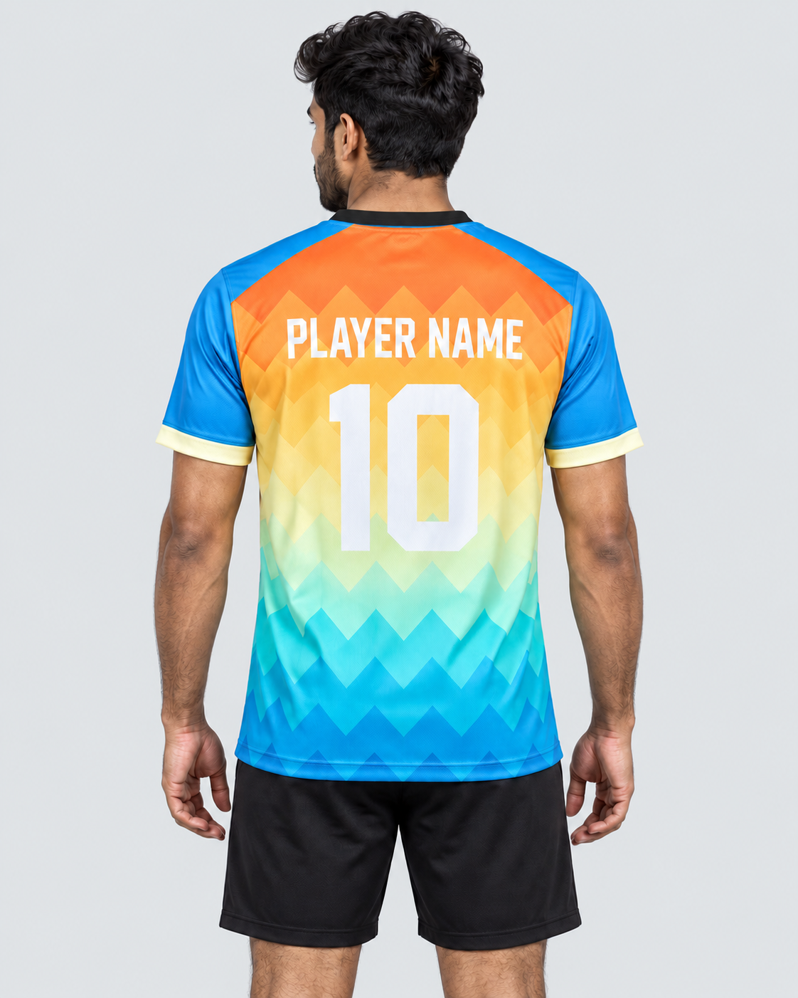 Back view of the orange, golden-yellow, mint, and cyan chevron sports jersey with a black collar and PLAYER NAME 10, worn with plain black sports shorts