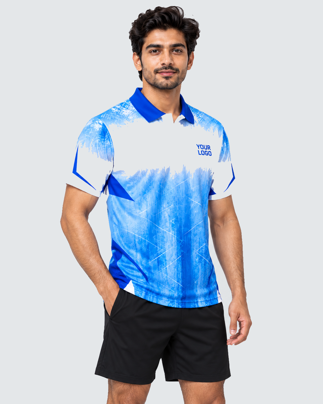 Three-quarter view of white and ice-blue sports jersey with YOUR LOGO and plain black shorts on solid #E4E7E9