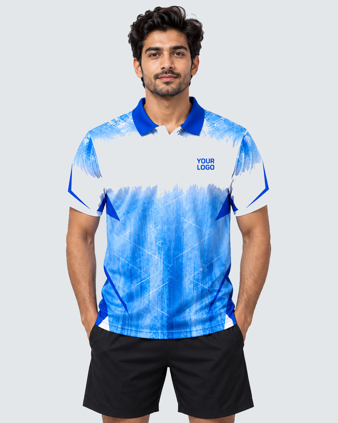 Front model view of white and ice-blue geometric sports jersey with YOUR LOGO and plain black shorts on solid #E4E7E9