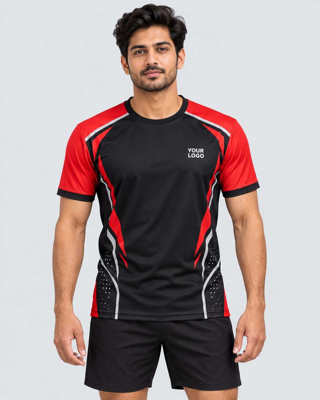Front view: Indian model wearing black and red custom sports jersey with YOUR LOGO chest placeholder