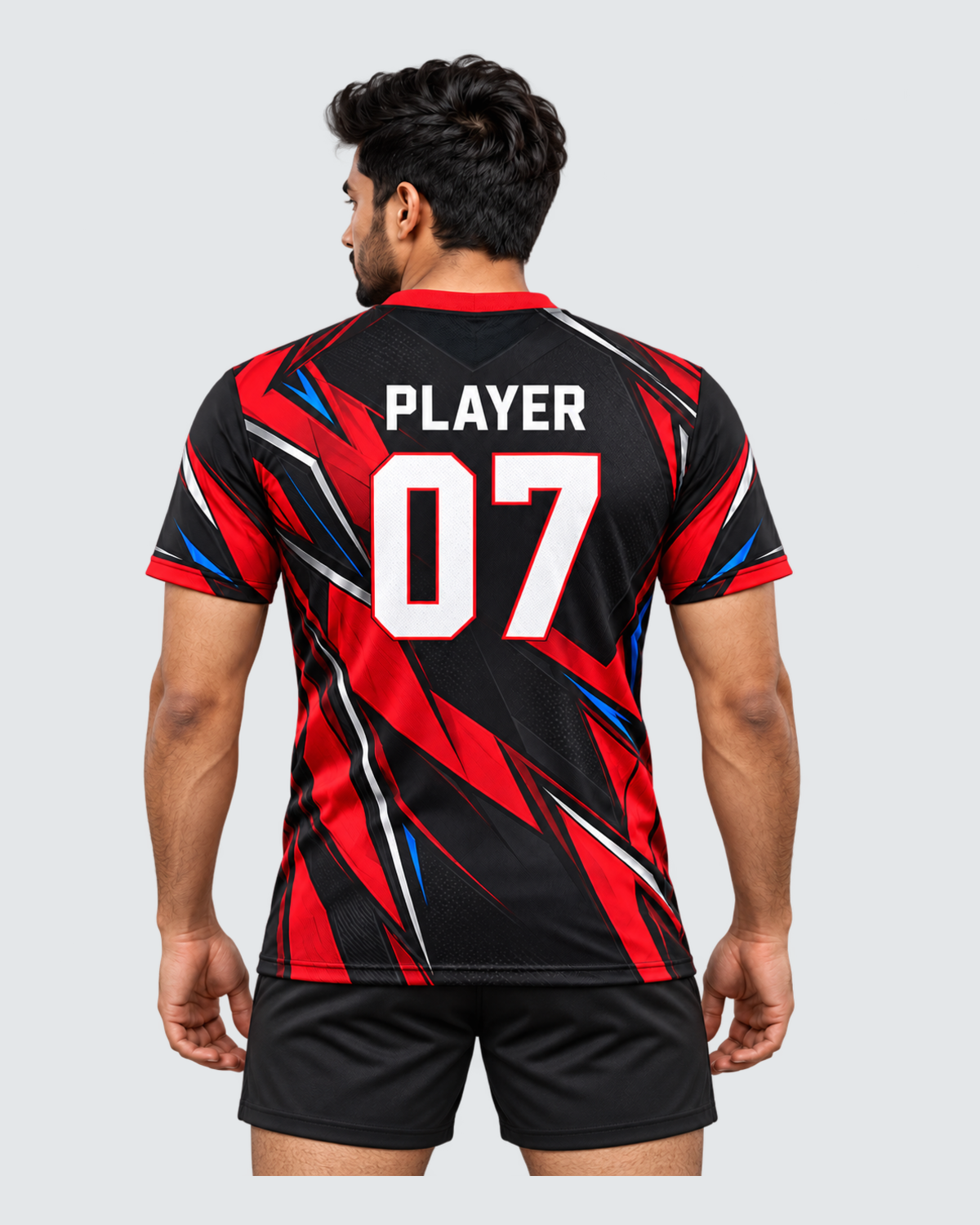 Crimson Flux, Back view with PLAYER and 07 placeholders; Indian male model, black sports shorts, solid #E4E7E9 background, portrait 4:5