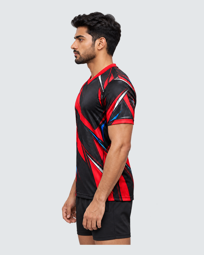 Crimson Flux, Opposite profile; Indian male model, black sports shorts, solid #E4E7E9 background, portrait 4:5