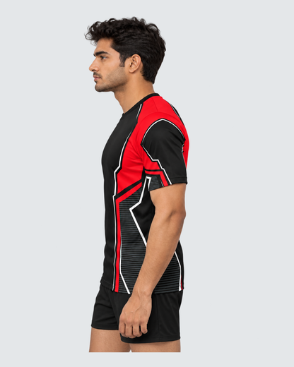 Crimson Frame, Left profile; Indian male model, black sports shorts, solid #E4E7E9 background, portrait 4:5