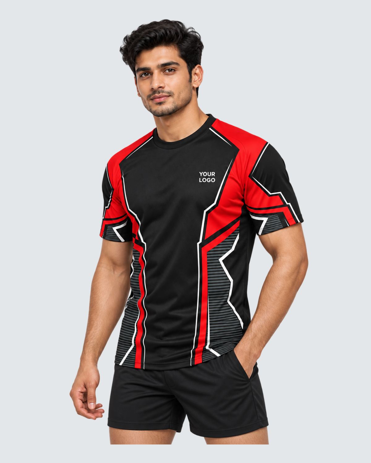 Crimson Frame, Three-quarter front view; Indian male model, black sports shorts, solid #E4E7E9 background, portrait 4:5
