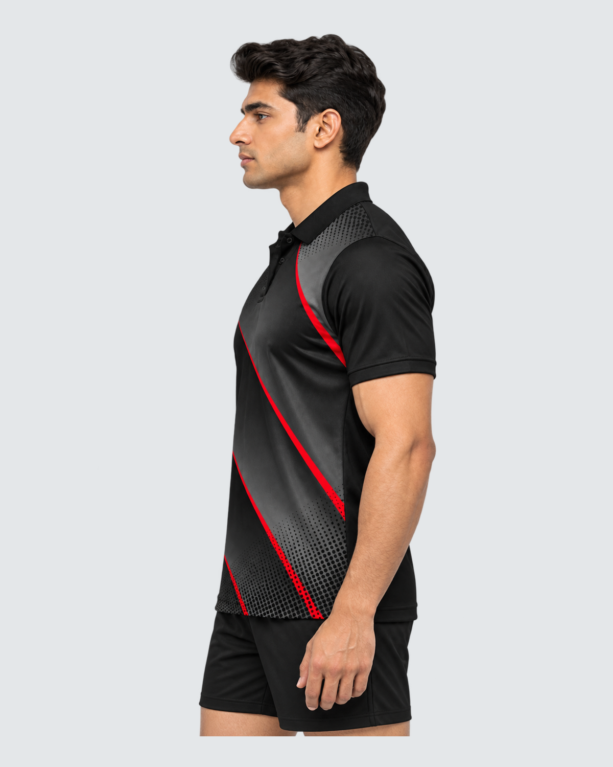 Obsidian Rush, Left profile; Indian male model, black sports shorts, solid #E4E7E9 background, portrait 4:5