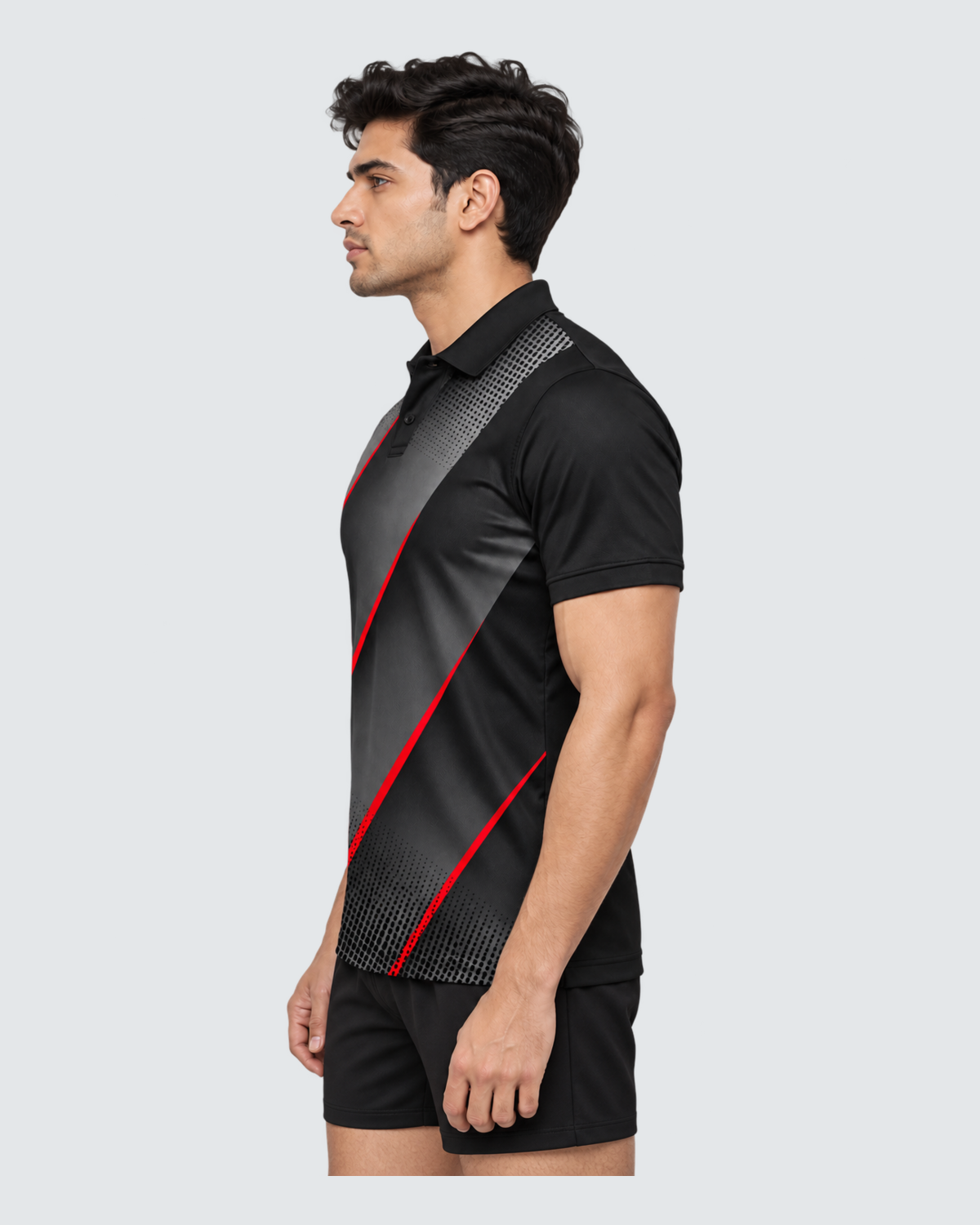 Obsidian Rush, Opposite profile; Indian male model, black sports shorts, solid #E4E7E9 background, portrait 4:5