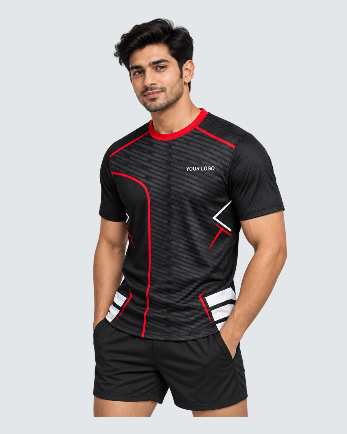 Redline Shadow, Three-quarter front view; Indian male model, black sports shorts, solid #E4E7E9 background, portrait 4:5