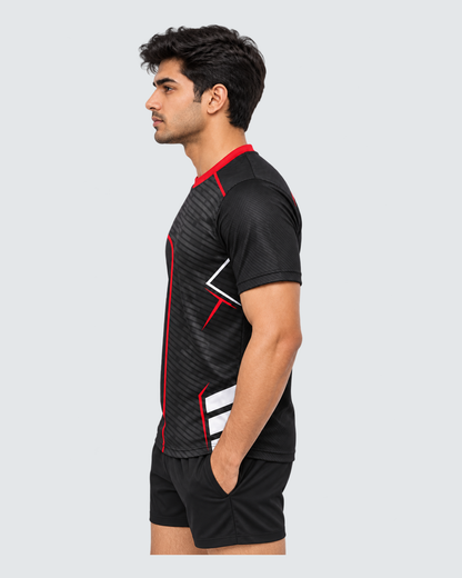 Redline Shadow, Opposite profile; Indian male model, black sports shorts, solid #E4E7E9 background, portrait 4:5